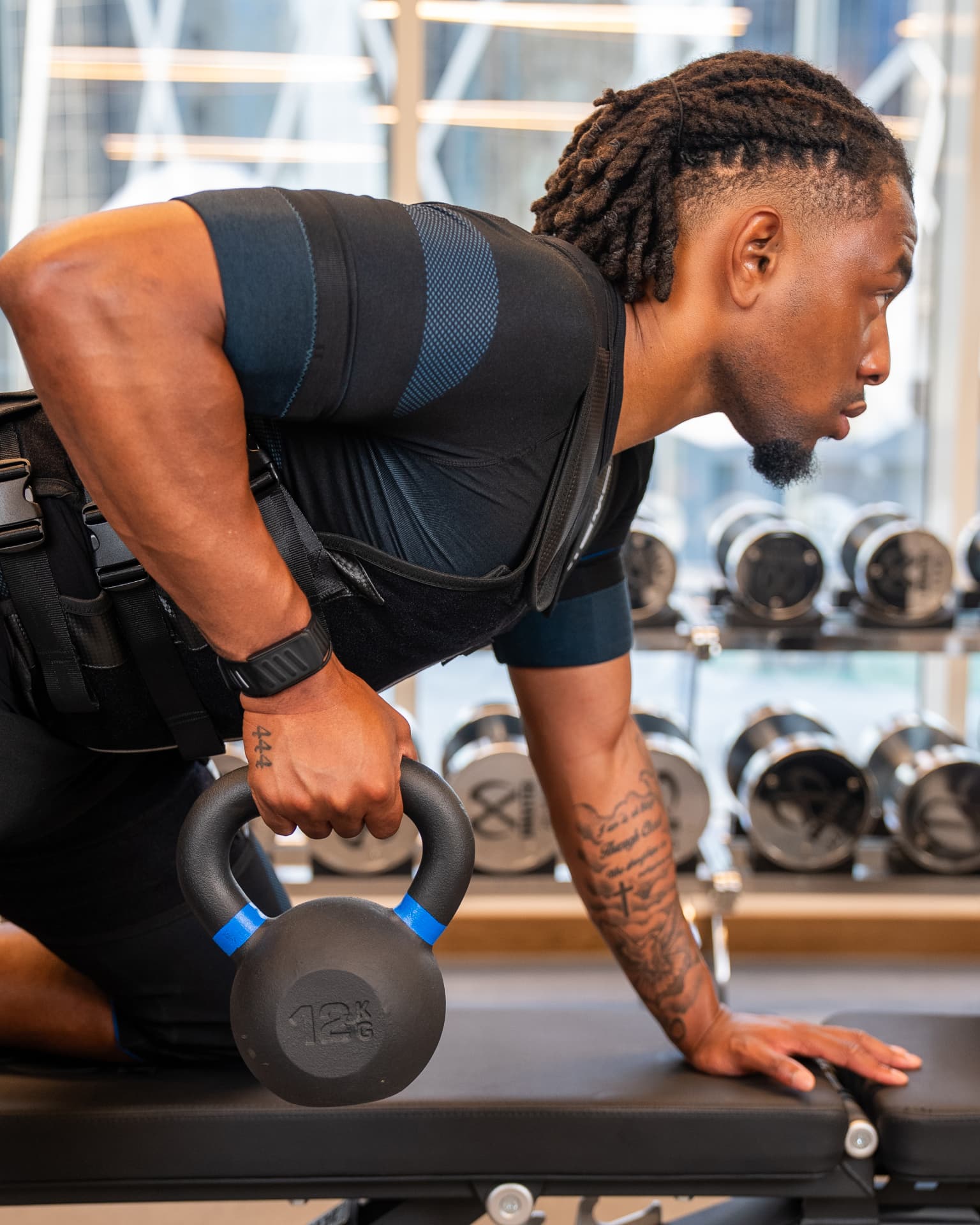 Studio 11 athlete training with a kettlebell in an EMS suit